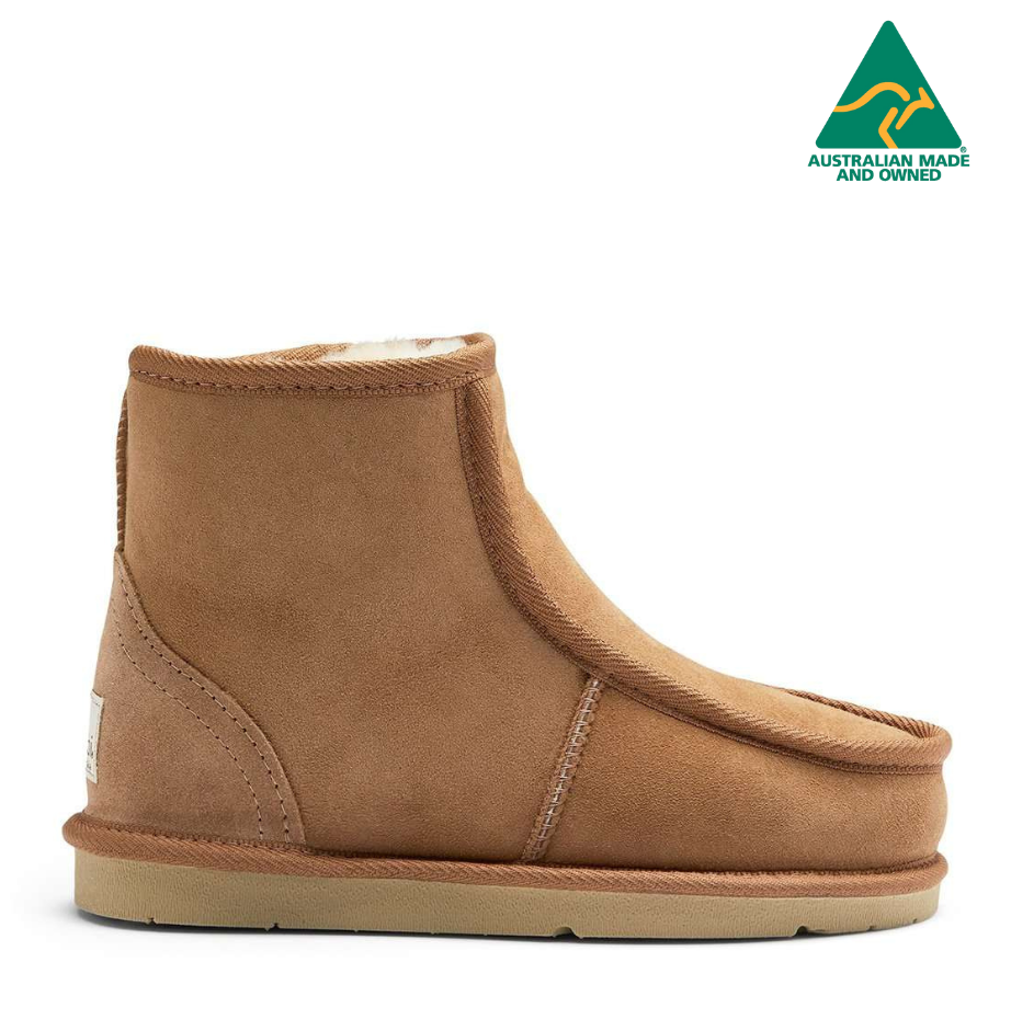 A brown sheepskin boot with a rubber sole, designed for comfort and warmth.