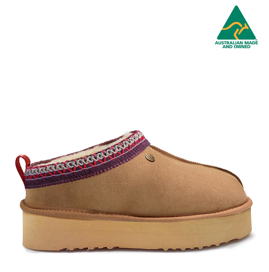 A brown Jasper Platform slipper with double faced sheepskin and a 4cm platform sole, featuring a patterned cuff and Australian Made flag.